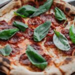 Pizza pepperoni z listkami świeżej bazylii